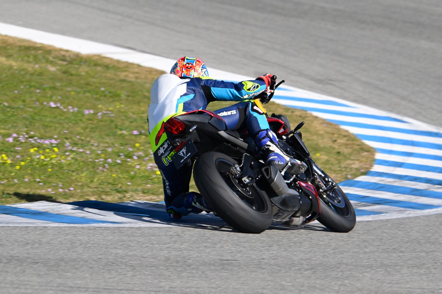 Neevesy riding the 2023 Triumph Street Triple 765 RS with knee down on the track